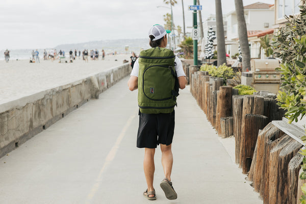 Person carrying an Aeronaut 45 walking along the Venice Beach, CA boardwalk.